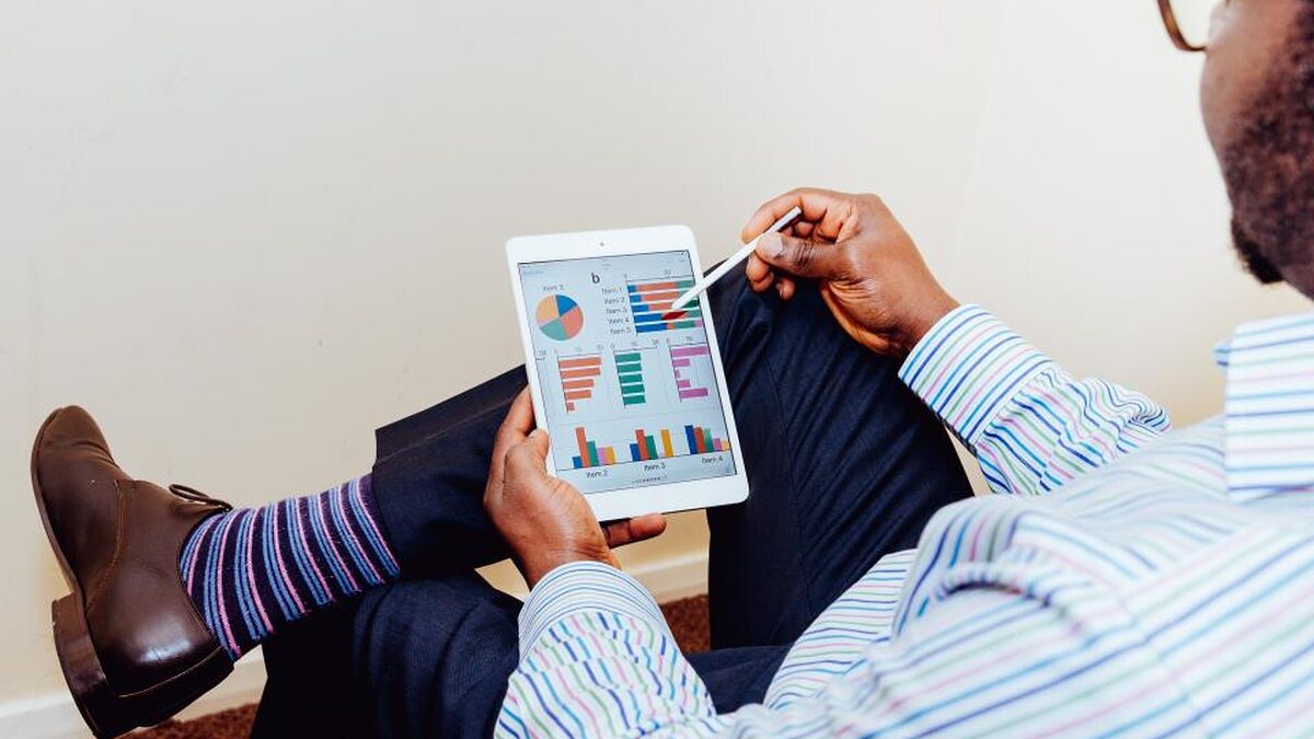 Someone reviewing performance charts on a tablet