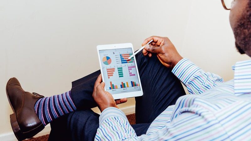 Someone reviewing performance charts on a tablet
