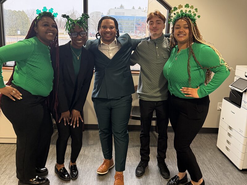 Five members of the EBM Marketing team in the office, wearing green for St Patrick&rsquo;s Day