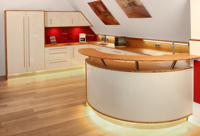 A modern curved reception desk in a bright office